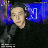park hyung jin is wearing headphones and glasses while singing into a microphone