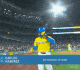 a baseball player wearing a yellow boston jersey