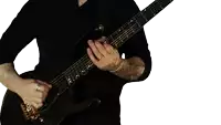 a man in a black shirt is playing a black electric guitar