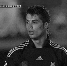 a black and white photo of a man in an adidas shirt