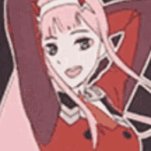a girl with pink hair and green eyes is wearing a red jacket .