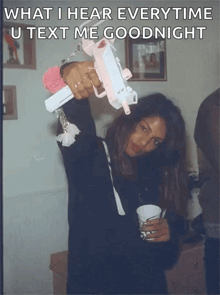 a woman holding a gun with the words what i hear every time u text me goodnight above her