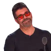 a man wearing sunglasses and a black shirt smiles