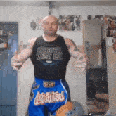 a man wearing a robota must isc shirt and blue shorts