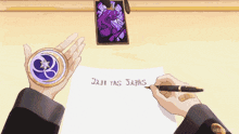 a person is writing on a piece of paper with a pen and holding a coin