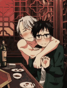 a couple of anime characters are hugging each other at a table with a bottle of olive oil in the background