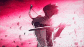 a person is holding a sword in their hand in front of a red sky .
