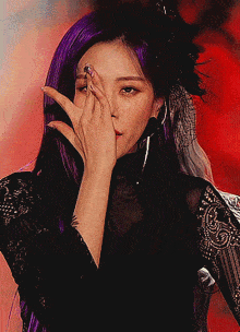 a woman with purple hair is giving a thumbs up sign