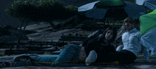 a woman laying on the ground with a yellow tape around her feet