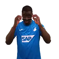 a man wearing sunglasses and a blue shirt with the word sap on the front