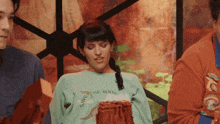 a woman wearing a shirt that says save the roots looks down