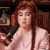a woman with red hair and a microphone that says call her daddy on it