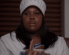 a woman wearing a white hat and a t-shirt that says ' goose ' on it