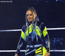 a woman in a wrestling ring with the name thekamdreesen on the bottom right