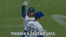 a baseball player is waving his hand in the air while standing on a field .