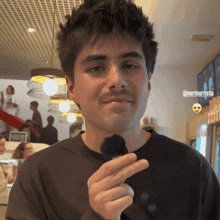 a man is holding a sony microphone in his left hand