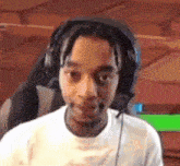 a man wearing headphones is sitting in a chair .