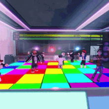 a group of people are dancing on a colorful dance floor and one of them has a skeleton on his shirt