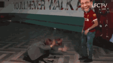 a man in a red shirt with the word liverpool on the bottom right