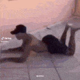 a shirtless man is doing push ups on the floor