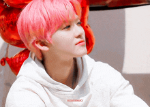 a boy with pink hair is wearing a white hoodie that says ' nana1013.com ' on it