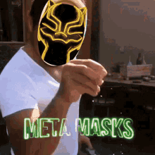 a man wearing a black panther mask is pointing at the camera with the words meta masks behind him