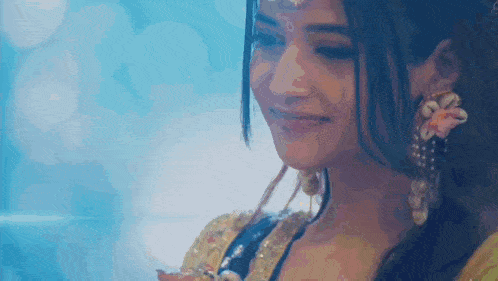 a close up of a woman 's face with a blue background behind her