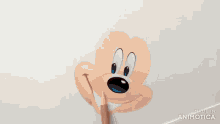 a person is drawing mickey mouse with a pencil