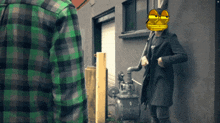a man in a green plaid shirt stands next to another man