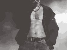 a man without a shirt is wearing a necklace and a belt