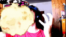 a person wearing headphones and a pink shirt has a yellow explosion coming out of their face