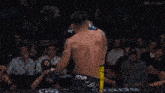 a man in a venum shorts is wrestling another man
