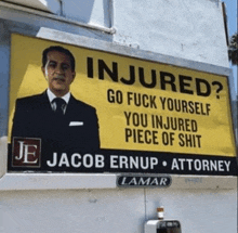 a billboard for jacob ernup attorney has a picture of a man in a suit and tie