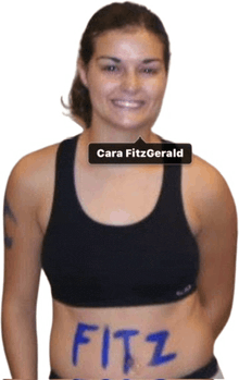 a woman with the name cara fitzgerald written on her belly