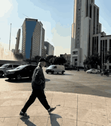 a man is walking in front of a building that says barcelo