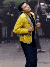 a man in a yellow jacket is dancing in front of police