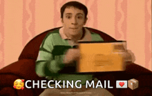 a man is sitting in a chair holding an envelope with the words checking mail below him