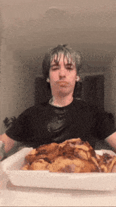 a man is eating a tray of food with his mouth covered in food