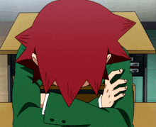 a person with red hair sits at a desk