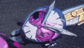 a close up of a clock with a purple face and a purple and white face .