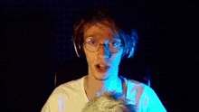 a close up of a person wearing headphones with a blue background