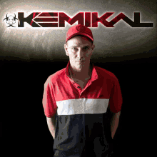 a man stands in front of a kemika logo