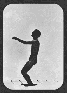 a black and white photo of a person doing a back flip