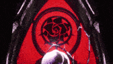 a red circle with a black rose in the center