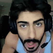 a man with a beard wearing headphones with a microphone