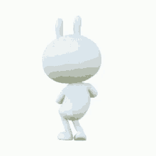 a white rabbit is standing on its hind legs and looking at the camera .