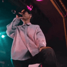a man singing into a microphone on stage