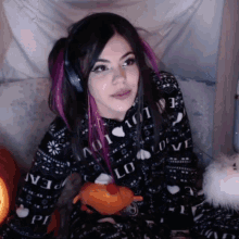 a woman wearing headphones and a sweater that says love