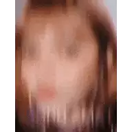 a blurry picture of a woman 's face with long hair