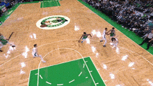 basketball players on a court with the celtics logo